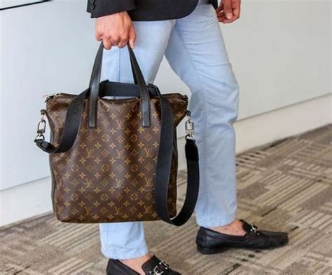 man cuts louis vuitton bag in store